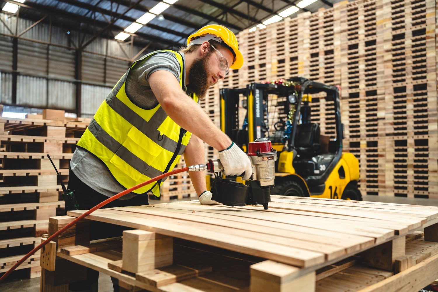 Worker building a new custom wood pallet